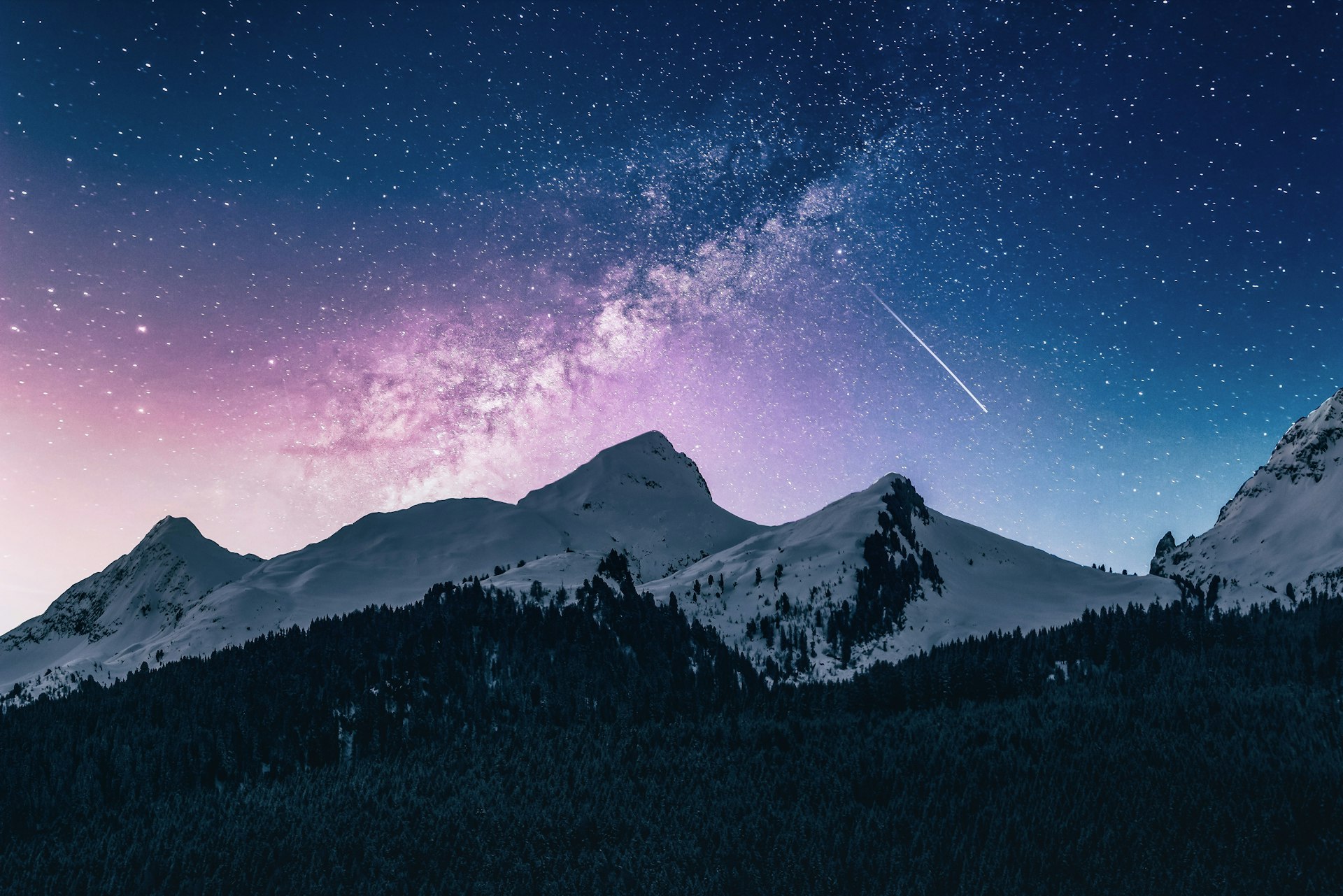 Starry night sky with constellation patterns over mountains
